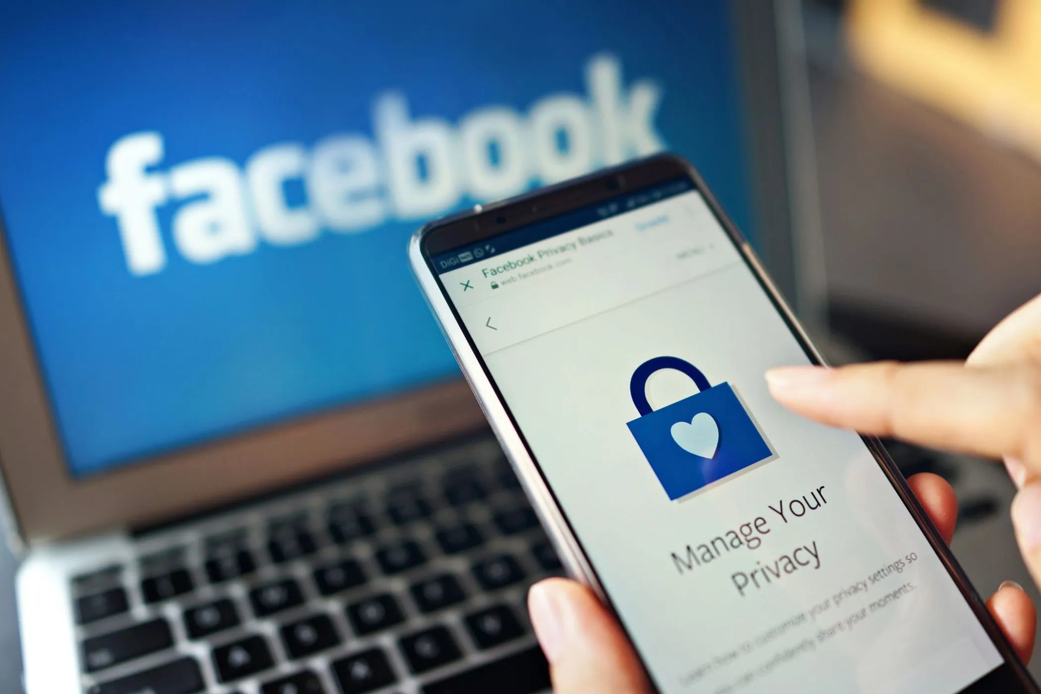 a person using the manage your privacy option on facebook on a smartphone