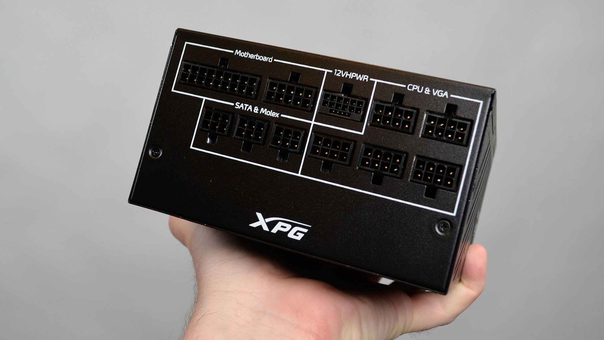 An XPG Core Reactor II 1200W power supply on a desk